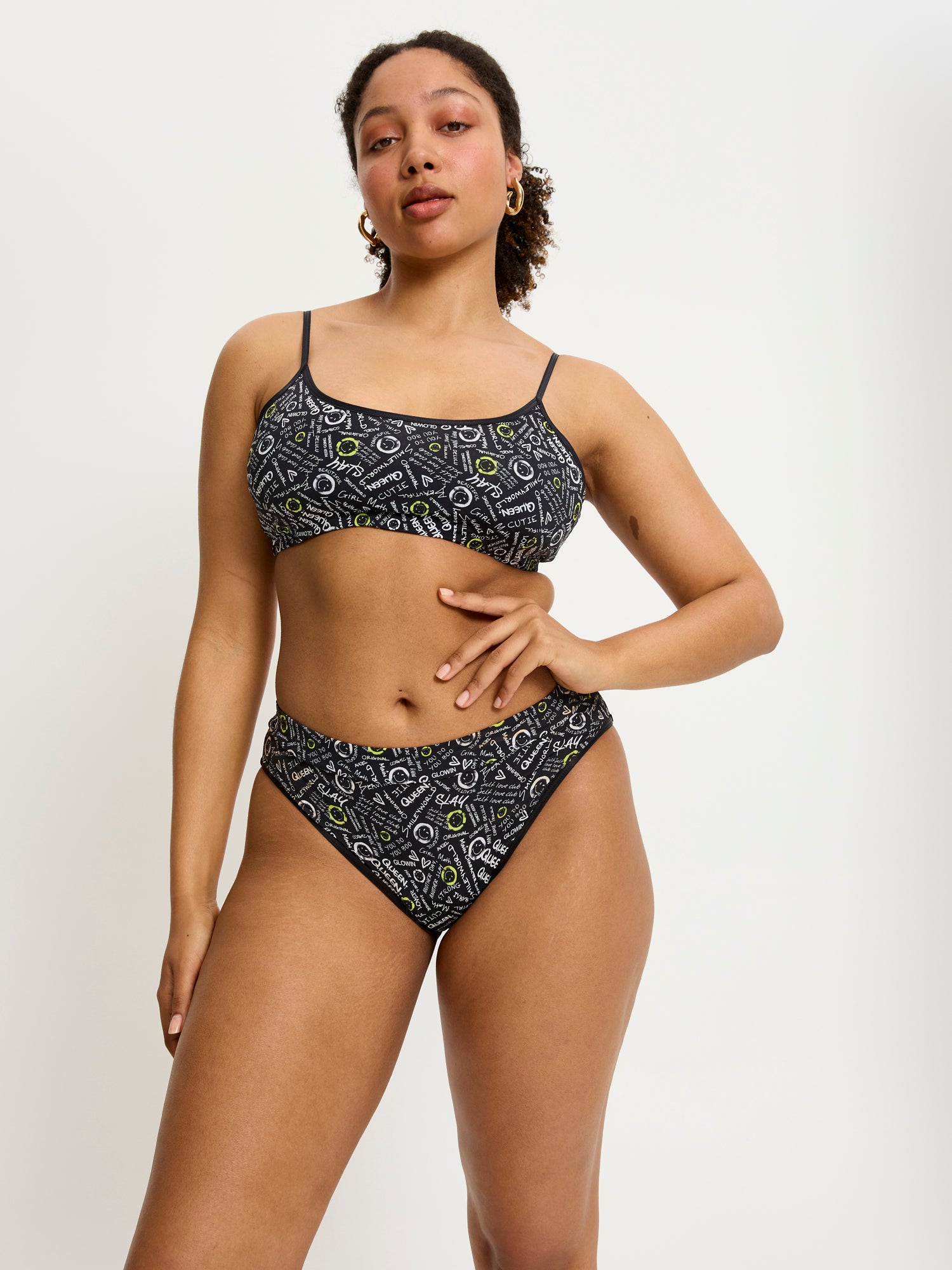 דוגמנית לובשת את הטופ של סמיילי-וורלד, מבט מהחזית. מידת הדוגמנית: L